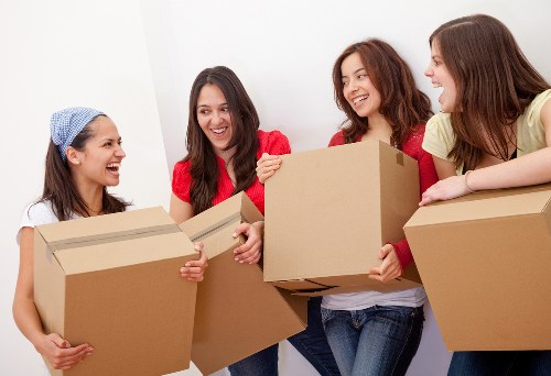 Moving team loading furniture and boxes into a removal van