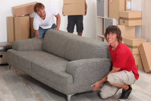 Furniture and boxes being loaded into a moving truck in Hackney
