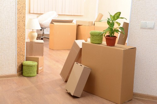 Moving boxes and furniture being loaded into a removal truck